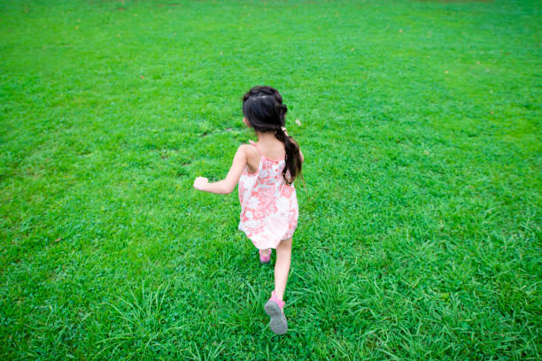 istock Girl play on the lawn 1018822098