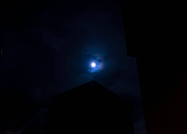 istock The Moon at night time with building silhouettes 1018824240
