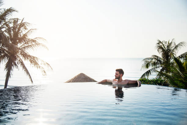 istock Handsome guy relaxing in swimming pool 1018824830