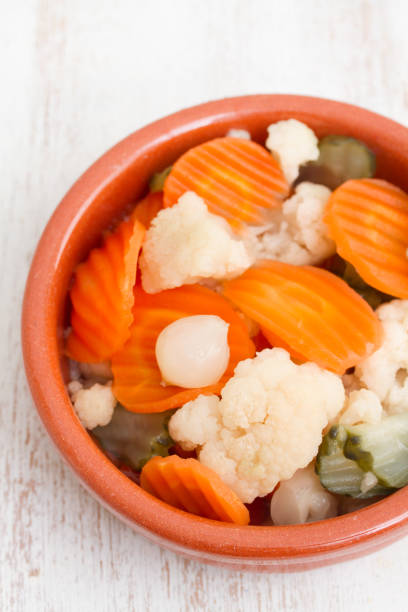 istock Pickled vegetables in ceramic dish on wooden background 1018831782