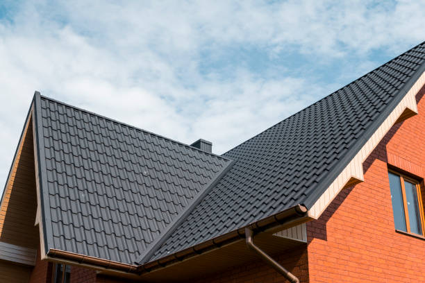 Modern roof covered with tile effect PVC coated brown metal roof sheets. stock photo