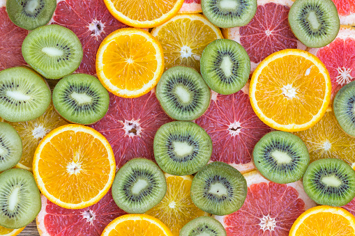 Fruit textures. Fruits sliced, kiwi, orange, grapefruit, Beautiful delicious fruit wallpaper. Colorful fresh fruits in rainbow colors.