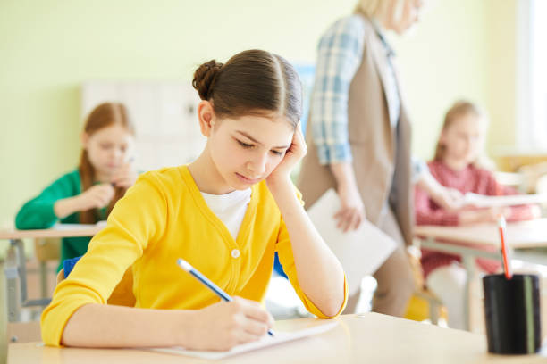 istock Puzzled schoolgirl passing important test 1018839316
