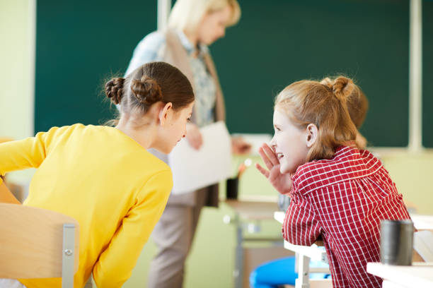 istock Jolly girls gossiping at class 1018839332