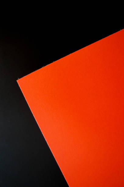 istock Dark flat lay background with color paper sheets. Black and red. 1018839942