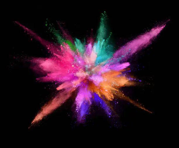 Photo of Coloured powder explosion isolated on black background