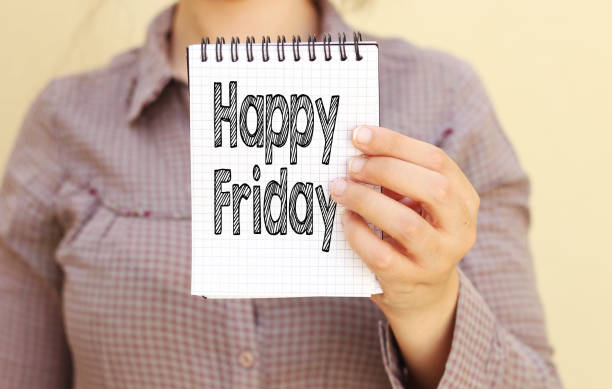 istock business woman holding notebook with happy friday text 1018869348