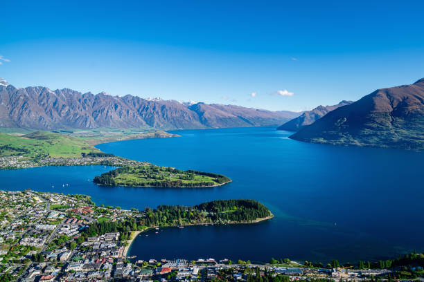 New Zealand Queenstown Summer Aerial View Remarkables Aerial view over the city of Queenstown towards the Remarkables mountains in the south-west of the South Island of New Zealand on a sunny summer day. Queenstown, Otago, South Island, New Zealand, Oceania dunedin new zealand stock pictures, royalty-free photos & images