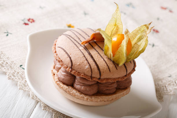 istock Elegant dessert: macaroon with chocolate cream decorated with physalis close-up. horizontal 1018873320