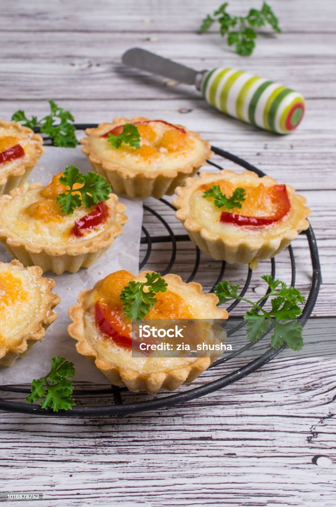 Tartlets with vegetables Tartlets with vegetables and cheese on wooden background. Selective focus. Appetizer Stock Photo