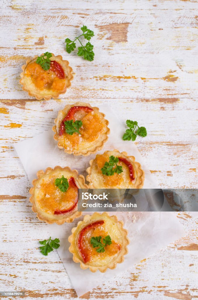 Tartlets with vegetables Tartlets with vegetables and cheese on wooden background. Selective focus. Appetizer Stock Photo