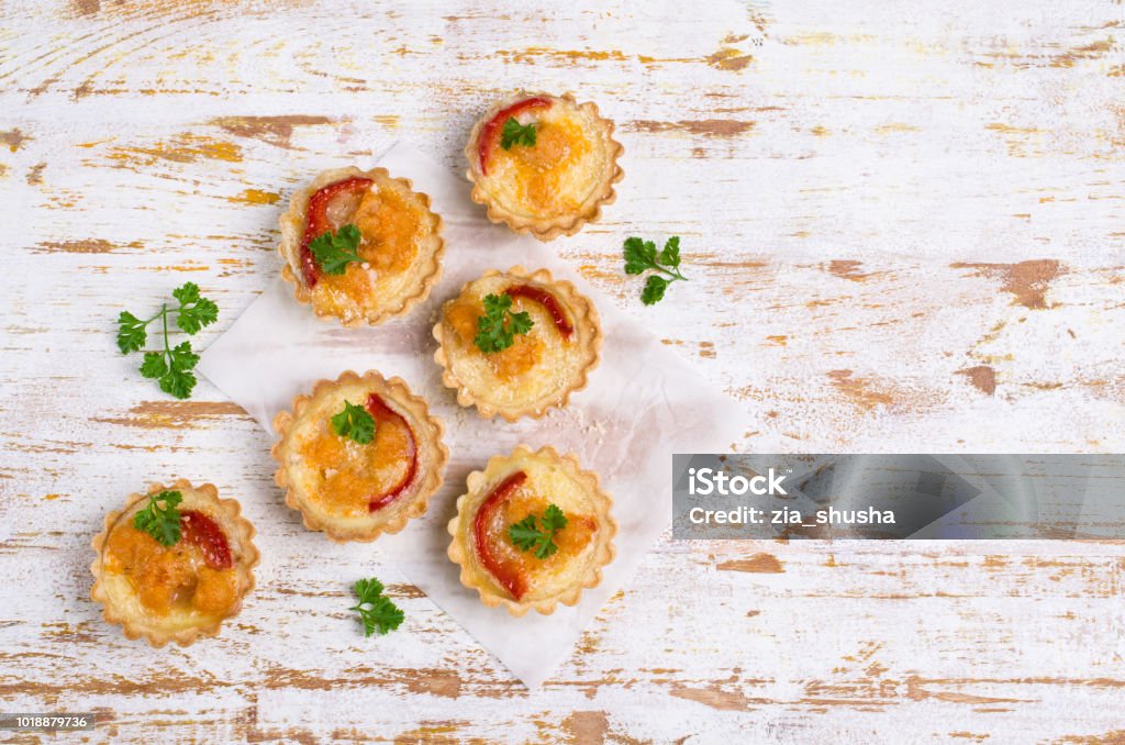 Tartlets with vegetables Tartlets with vegetables and cheese on wooden background. Selective focus. Appetizer Stock Photo