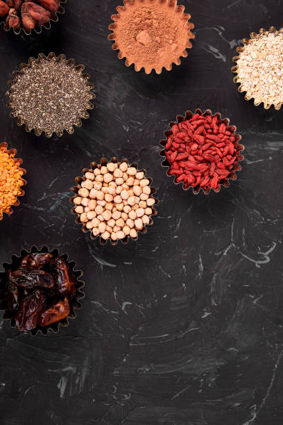 various superfoods in small bowl on blue background - quinoa sesame chia flax seed imagens e fotografias de stock