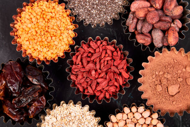 various superfoods in small bowl on blue background - quinoa sesame chia flax seed imagens e fotografias de stock