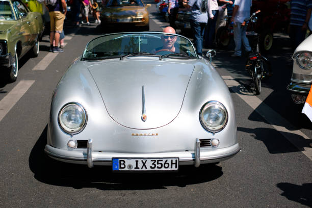 Baden-Baden, Germany - 10 July 2022: yellow Porsche 356 1948 coupe is parked in Kurpark in Baden-Baden at the exhibition of old cars \