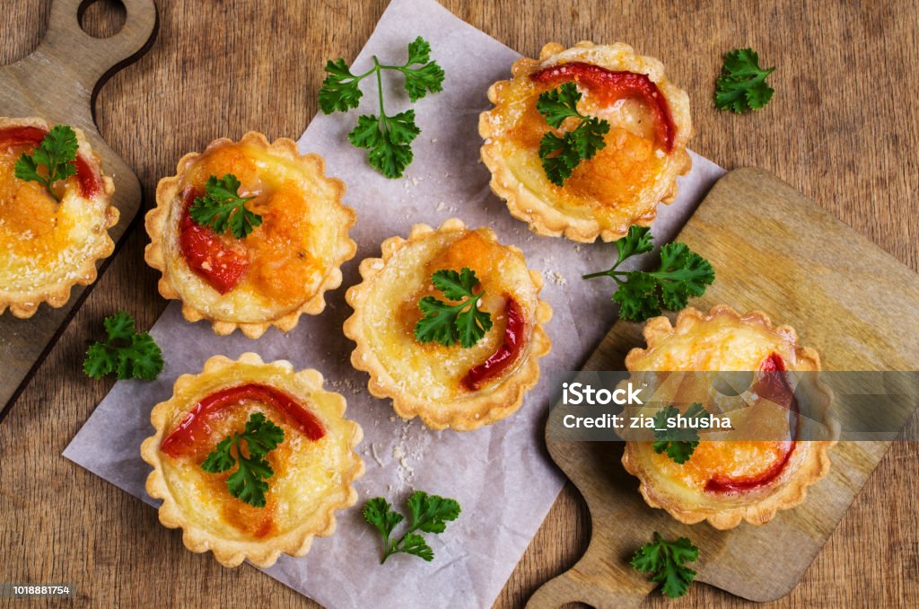 Tartlets with vegetables Tartlets with vegetables and cheese on wooden background. Selective focus. Appetizer Stock Photo