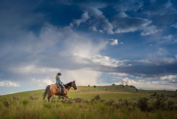 istock Cowgirl with her horse 1018884162