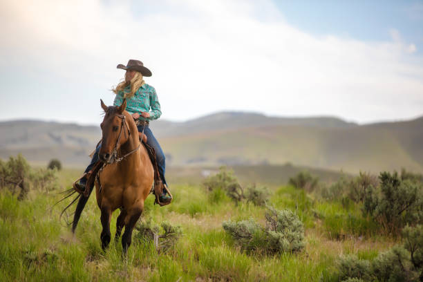 istock Cowgirl with her horse 1018886440