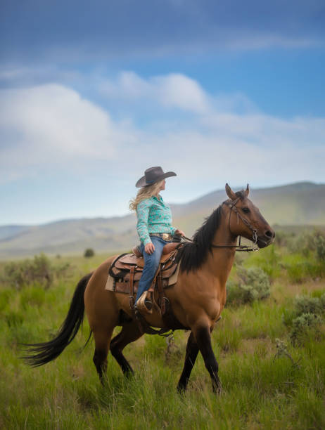 istock Cowgirl with her horse 1018888566