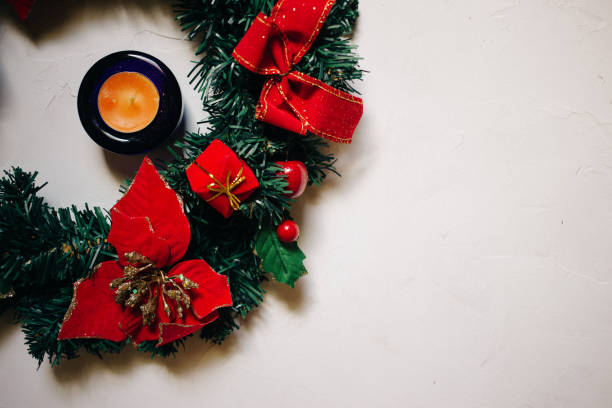 istock decorated Christmas wreath and candles, copy space, top view, white plastered background 1018888662