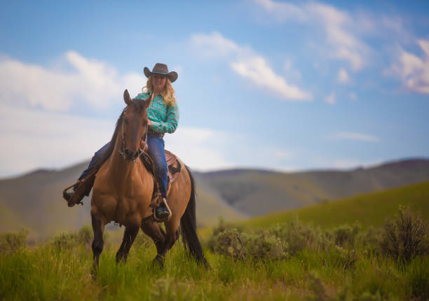 istock Cowgirl with her horse 1018888694