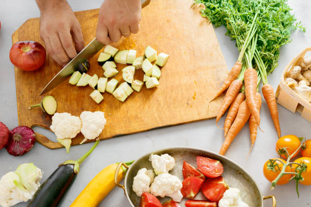 istock Man hands cuts vegetables cooking vegetable stew 1018890578