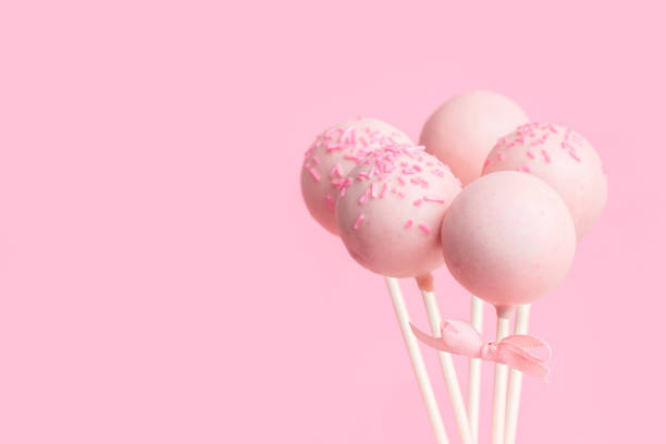 istock festive glazed cake pops over pink background with copy space, close up 1018897608
