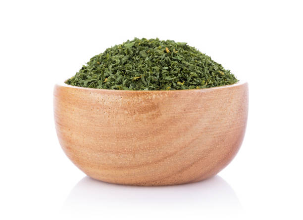 istock dried parsley in bowl isolated on white background 1018903974