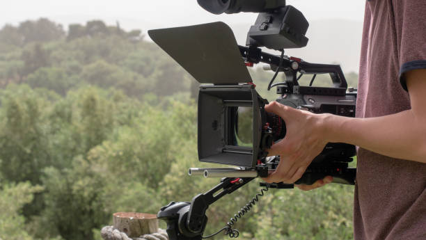 istock cameraman looking for the perfect shot 1018905316