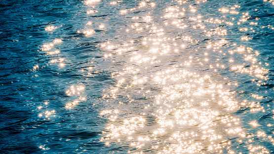 A water surface glittering with reflected sunlight.
