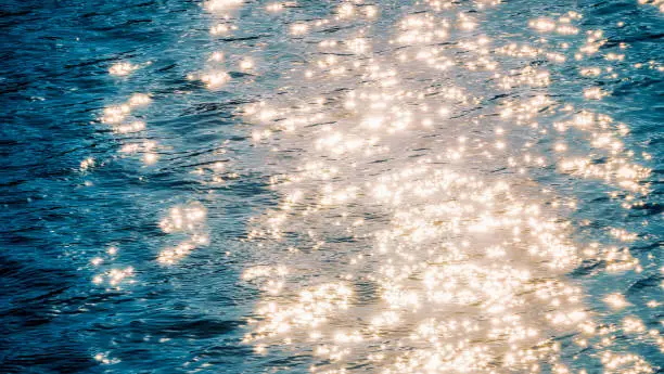 Photo of Glittering sunlight on soft waves