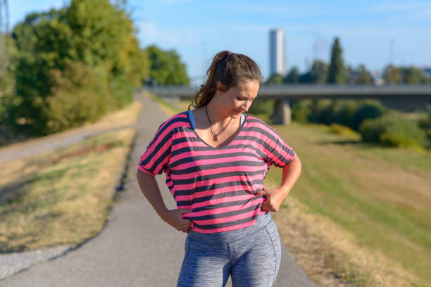 istock Upset young woman looking at her belly fat 1018914294