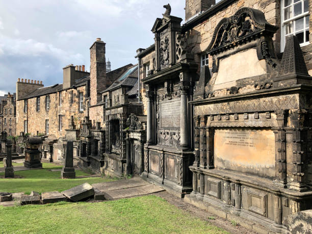 Tombs in Greyfriars Kirkyard - Edinburgh - Scotland Tombs in Greyfriars Kirkyard. A graveyard surrounding Greyfriars Kirk in Edinburgh, Scotland. kirkyard stock pictures, royalty-free photos & images