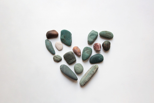 Sea stones heart shaped valentine isolated on white background