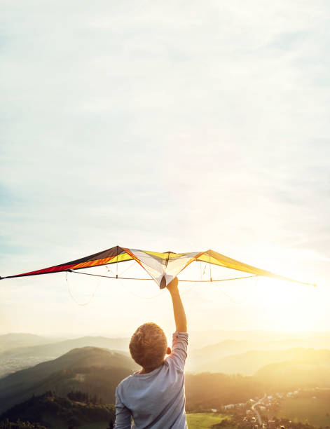 istock In dreams about flying. Boy takes a kite over his head 1018926144