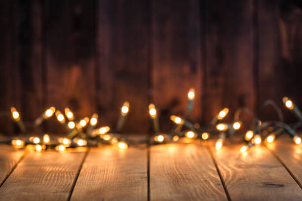 istock Empty rustic wooden table with blurred Christmas lights at background 1018936480