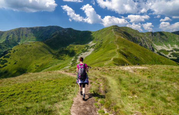 istock Walking woman hiking on the mountains 1018937024