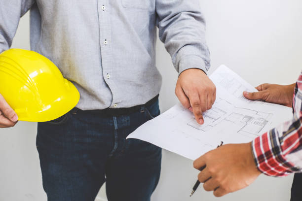 istock Architect or Engineer meeting working with partner on blueprint for architectural project in progress, construction and structure concept 1018937124