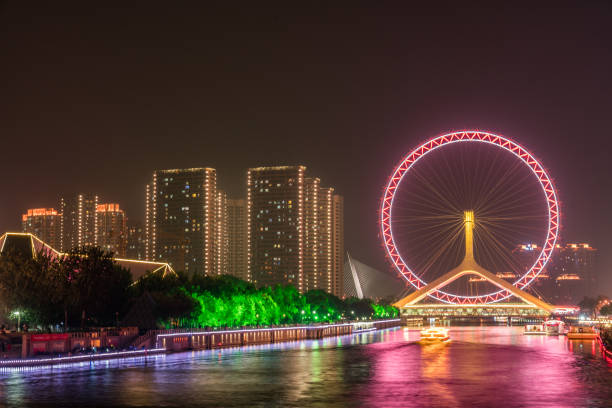 a ferris wheel built on a bridge in tianjin, China