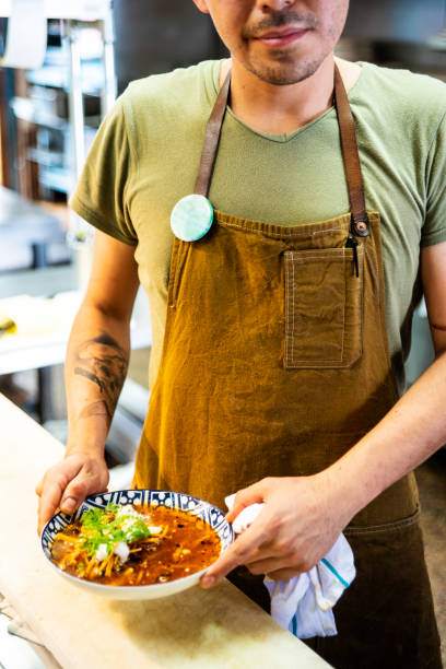 istock Mexican chef serving Aztec soup in an authentic Mexican restaurant 1018942718