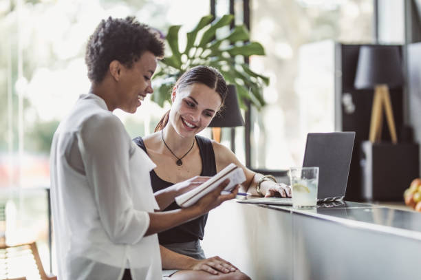 istock Two Young Businesswomen at a Cafeteria 1018943218