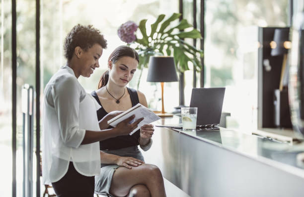 istock Two Young Businesswomen at a Cafeteria 1018943260