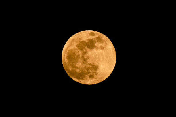 istock The yellow full moon on black background 1018951650