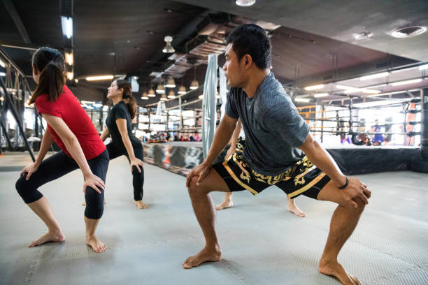 istock Relaxation and stretching exercises - Training class at the boxing gym 1018959316