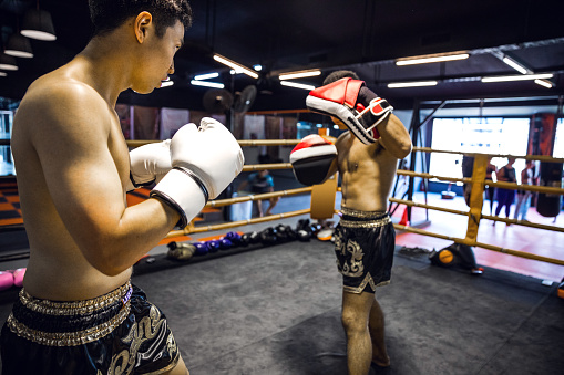 Muay Thai match on boxing ring in Thailand