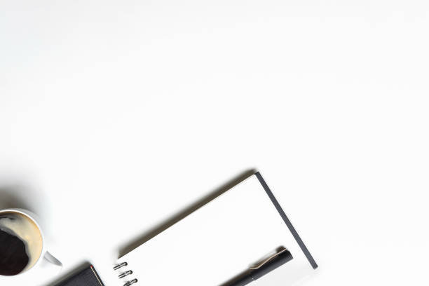 istock Office desk with notebook paper, pen and coffee cup top view workspace. 1018962292