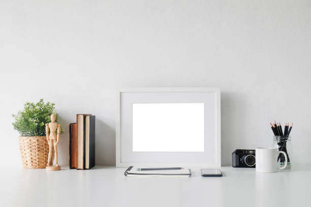 istock Stylish workspace with poster, book and gadget. Workplace desk and copy space. 1018962876