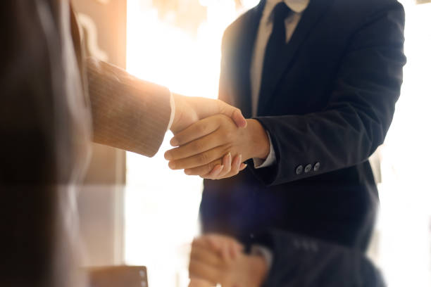 istock Business partnership handshake concept.Photo two coworkers handshaking process.Successful deal or acquisition after great meeting. 1018962968