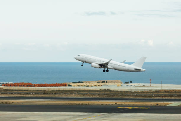 istock departure of white jet airplane 1018963338