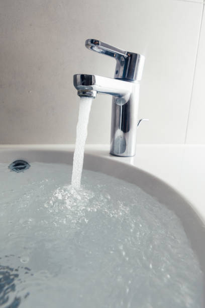 istock faucet and wash sink with flowing water 1018963378